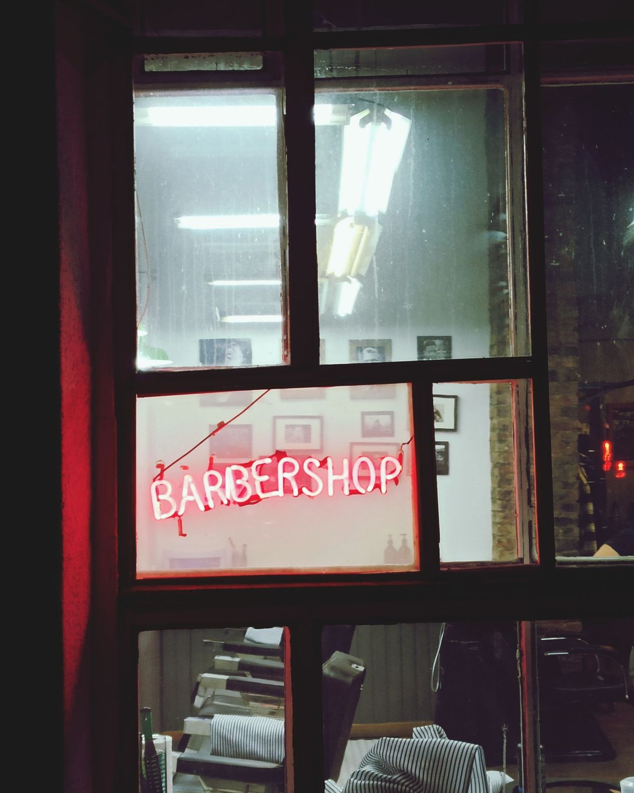 Vitrine de barbearia iluminada à noite
